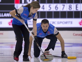 Portage la Prarie Mb.January 5, 2018.Canad Inn Mixed Doubles Curling Trials.Playoffs Round #2.John Morris of Canmore Ab,deliver his stone as playing partner Kaitlyn Lawes of Winnipeg Mb,brushes during thier 2nd round playoff against Brett Gallant St.John's N.L and Jocelyn Peterman of Calgary Ab. michael burns photo