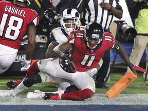 Atlanta Falcons wide receiver Julio Jones catches a touchdown pass past Rams defender John Johnson III during the fourth quarter of their NFC wild-card playoff game Saturday night, in Los Angeles.