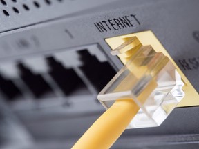 In this stock photo, an ethernet cable connects to a router.