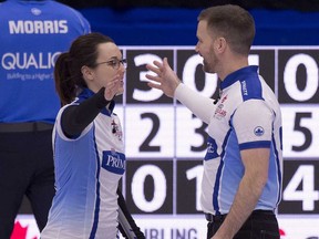 Val Sweeting and Brad Gushue congratulate each other after defeating John Morris and Kaitlyn Lawes to gain a berth in Sunday's final of the trials.