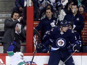 Vancouver forward Thomas Vanek is flattened by Winnipeg’s Tyler Myers during the first period of last night’s 1-0 Jets win. Myers and his mates didn’t give the Canucks much room to operate. The Canadian Press