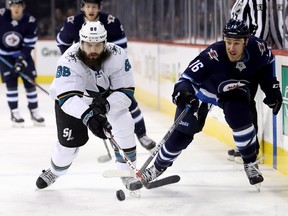 San Jose Sharks' Brent Burns (88) and Winnipeg Jets' Shawn Matthias (16) race for the puck during first period action Sunday.