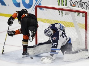 Winnipeg Jets goaltender Connor Hellebuyck stops a shot by Anaheim Ducks' Rickard Rakell during the shootout Thursday.