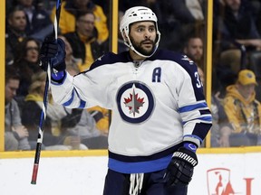 Winnipeg Jets defenseman Dustin Byfuglien celebrates after scoring a goal against the Nashville Predators during the first period of an NHL hockey game, Monday, March 13, 2017, in Nashville, Tenn. (AP Photo/Mark Humphrey) ORG XMIT: TNMH103 ORG XMIT: POS1703132007167910