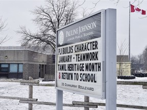A sign outside of Pauline Johnson Junior Public School is seen in Toronto on Monday. A Toronto police investigation has concluded that an incident reported by an 11-year-old girl who claimed her hijab was cut by a scissors-wielding man as she walked to school did not happen.