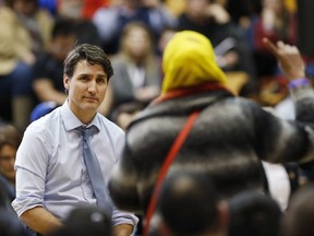 Prime Minister Justin Trudeau listens to a question about Child and Family Services at a town hall meeting at the University of Manitoba in Winnipeg, Wednesday, January 31, 2018. THE CANADIAN PRESS/John Woods ORG XMIT: JGW122