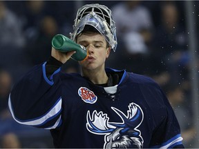 Eric Comrie made 41 saves as the Manitoba Moose held on for a 2-1 victory over the Stockton Heat in American Hockey League action Friday.