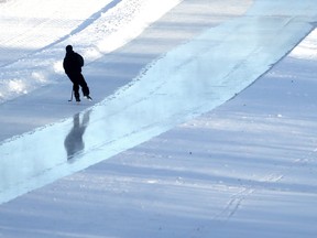 A skater is reflected in freshly flooded ice on the Assiniboine River, in Winnipeg.