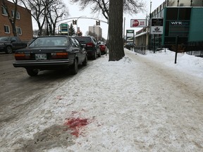 Blood remains near the sidewalk on Corydon Avenue near Bar Italia on Sunday, Jan. 7, following an assault that occurred in the early morning hours. On Saturday, four men were charged with aggravated assault in the incident which sent two men to hospital in serious condition suffering from stab wounds.