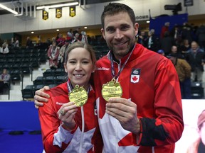Kaitlyn Lawes and John Morris display their gold medals after winning the mixed doubles Olympic trials final over Brad Gushue and Val Sweeting in Portage la Prairie, Man., on Sun., Jan. 7, 2018.