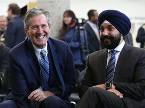 Premier Brian Pallister (left) and federal Innovations Minister Navdeep Bains share a laugh prior to an announcement of funding for high-speed internet in rural and remote Manitoba communities at the Millennium Library, earlier this month.