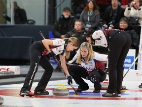 Third Kaitlyn Lawes (left) and second Jill Officer sweep under the watchful eye of skip Jennifer Jones during the final of the Manitoba women's curling championship on Sunday. The five-time Canadian champion skip needs a new third to replace Kaitlyn Lawes for the national Scotties, Jan.27-Feb. 4, in Penticton. B.C., because Lawes is headed for the Winter Olympics in mixed doubles along with teammate John Morris.