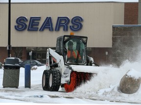 Mall staff clear the sidewalks near Sears at St. Vital Centre in Winnipeg on Sun., Jan. 14, 2018. Kevin King/Winnipeg Sun/Postmedia Network