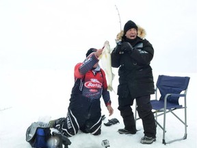 Rick Mercer (right) shows off his fishing skills.