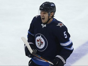 Winnipeg Jets defenceman Dmitry Kulikov skates off in discomfort after colliding with Chicago Blackhawks centre Jonathan Toews in Winnipeg on Thurs., Dec. 14, 2017. Kevin King/Winnipeg Sun/Postmedia Network