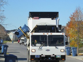 An Emterra Environmental recycling truck picks up bins in south Winnipeg on Saturday, Oct. 6, 2012. The City of Winnipeg has file a statement of defence against claims against it by Emterra.