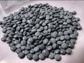 Fentanyl pills are shown in an undated police handout photo. Council's protection, community services and parks committee will be asked July 3 to consider moving $150,000 once earmarked for hazardous material suits in 2016 to instead pay for a portable hazardous substance analysis tool to quickly identify fentanyl and other hazardous materials.