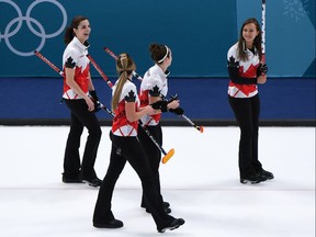 Canada's players leave the ice with smiles after beating the United States for their first victory on Feb. 17, 2018.