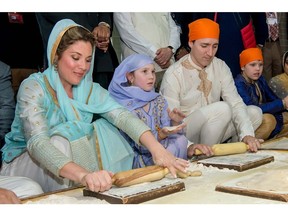 In this photograph released by the Amritsar District Public Relations Officer on February 21, 2018, Prime Minister Justin Trudeau (second from right), his wife Sophie Gregoire Trudeau (left), daughter Ella-Grace and son Xavier prepare chappati for a communal vegetarian meal known as 'langar' at a community kitchen at the Golden Temple in Amritsar.