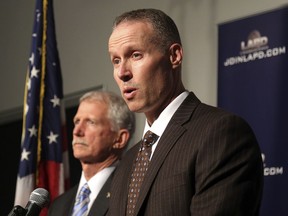 Justin Eisenberg, the chief of detectives for the Los Angeles Police Department, right, speaks at a news conference in Los Angeles at police headquarters alongside Capt. William Hays, Tuesday, Feb. 6, 2018. (AP Photo/Mike Balsamo)