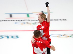 Canada's Kaitlyn Lawes and John Morris celebrate their gold medal win against Switzerland during mixed doubles at the 2018 Olympics in Gangneung, South Korea on Feb. 13, 2018