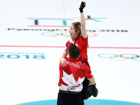 Canada's Kaitlyn Lawes and John Morris celebrate their gold medal in mixed doubles curling at the Pyeongchang Olympics on Feb. 13.