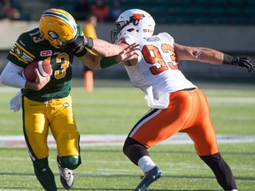EDMONTON, ALTA: ¬SEPTEMBER 26, 2015 -- Craig Roh (93) gets a face mask penalty on quarterback Mike Reilly (13) as the Eskimos beat the BC Lions 29-23 in Edmonton, September 26, 2015. (Photo by Bruce Edwards / Edmonton Journal)