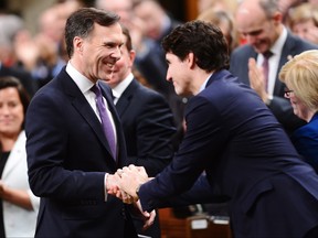Finance Minister Bill Morneau shakes hands with Prime Minister Justin Trudeau as he arrives in the House of Commons prior to tabling the federal budget in Ottawa on Tuesday, Feb.27, 2017. THE CANADIAN PRESS/Sean Kilpatrick ORG XMIT: SKP701
