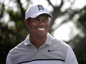 Tiger Woods smiles as he jokes with his playing partners during the Pro-Am for the Honda Classic golf tournament, Wednesday, Feb. 21, 2018, in Palm Beach Gardens, Fla.