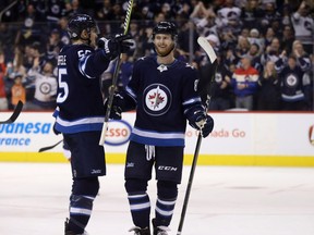 Winnipeg Jets centre Mark Scheifele (55) and left wing Kyle Connor (81) celebrate after Scheifele scored against the Florida Panthers during second period NHL hockey action in Winnipeg, Sunday, February 18, 2018. THE CANADIAN PRESS/Trevor Hagan ORG XMIT: WPGT116