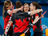 Rachel Homan hugs her teammates after they beat Switzerland during women's curling.