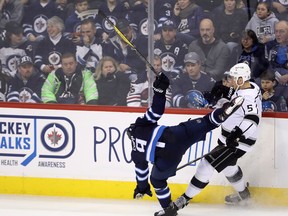 Winnipeg Jets' Andrew Copp goes flying after colliding with Los Angeles Kings' Christian Folin last night. THE CANADIAN PRESS