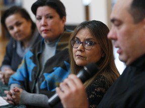 (From left) Jocelyne Bourbonnais, taken from her family in 1965 from Crane River, Man., and adopted to a family in Winnipeg, Colleen Rajotte, who was put in foster care in Winnipeg and adopted by a Winnipeg family and spokesperson for the Manitoba 60's Scoop Survivors Group, and Priscilla Meeches, who was taken from her family in 1969 in Portage La Prairie, Man., and adopted to a Manitoba Mennonite family listen in as Stewart Garnet, who was taken from family in Long Plain and moved to San Francisco, speaks at Thunderbird House in Winnipeg, earlier this year.