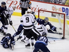 Los Angeles Kings' Torrey Mitchell scores on Winnipeg Jets goaltender Connor Hellebuyck last night. (THE CANADIAN PRESS)