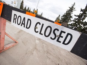 A road closed sign is seen as City of Edmonton crews work to prepare and clean Groat Road for re-opening on Groat Road south of 107 Avenue in Edmonton, Alta., on Monday, April 6, 2015. The road has been closed due to bent girders installed on the 102 Avenue Bridge project, which occured overnight on March 16. The road has been closed since. Ian Kucerak/Edmonton Sun/ QMI Agency