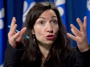 In this file photo, former Quebec Natural Resources Minister and current Bloc Quebecois leader Martine Ouellet responds to reporters questions on Thursday, December 5, 2013 at the legislature in Quebec City.