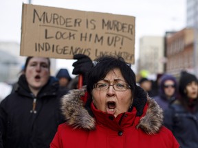 A marcher cries during a rally in response to Gerald Stanley's acquittal in the shooting death of Colten Boushie in Edmonton, Alta., on Saturday, February 10, 2018.