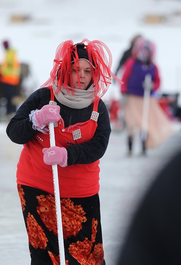 A competitor sweeps during the 17th annual Ironman Outdoor Curling Bonspiel on the Red River at The Forks in Winnipeg on Sun., Feb. 4, 2018. Kevin King/Winnipeg Sun/Postmedia Network