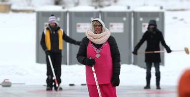 A competitor tracks her shot during the 17th annual Ironman Outdoor Curling Bonspiel on the Red River at The Forks in Winnipeg on Sun., Feb. 4, 2018. Kevin King/Winnipeg Sun/Postmedia Network