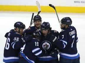 Winnipeg Jets forward Brendan Lemieux (centre) is excited for a goal from Nik Petan (19) against the Arizona Coyotes on Tuesday. (Kevin King/Winnipeg Sun/Postmedia Network)