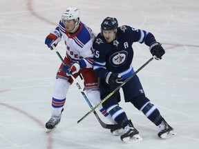 Winnipeg Jets centre Mark Scheifele leans on New York Rangers forward J.T. Miller in Winnipeg on Sun., Feb. 11, 2018. Kevin King/Winnipeg Sun/Postmedia Network