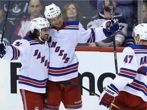 New York Rangers forward Michael Grabner (centre) celebrates his empty-net goal against the Winnipeg Jets with forward Mats Zuccarello (left) and defenceman Steven Kampfer on Sunday. Grabner and Zuccarello could both be on the Jets' radar for the NHL trade deadline.