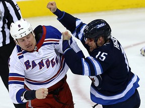 Winnipeg Jets centre Matt Hendricks (right) and New York Rangers forward Cody McLeod are both bleeding during a scrap in Winnipeg on Sun., Feb. 11, 2018. Kevin King/Winnipeg Sun/Postmedia Network