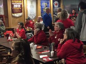 Members at the St. Vital Curling Club watch as Winnipeg's Kaitlyn Lawes and her partner John Morris win the gold medal in mixed doubles curling at the Winter Olympics in Gangneung, South Korea, Tuesday morning.