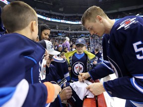 Tyler Myers signs autographs for fans during the Winnipeg Jets skills competition at Bell MTS Place in Winnipeg on Wed., Feb. 14, 2018. Kevin King/Winnipeg Sun/Postmedia Network