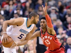 Raptors' Malcolm Miller guards Charlotte Hornets' Nicolas Batum during Sunday night's game. (THE CANADIAN PRESS)
