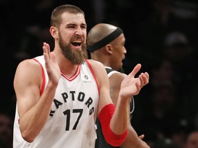 Raptors centre Jonas Valanciunas reacts toward the bench after earning a free-throw during against the Brooklyn Nets on Tuesday. (AP PHOTO)