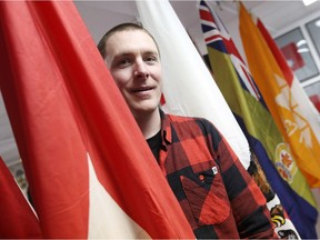 Shayne Campbell, who is the president and executive director of Settlers, Rails & Trails, show his pride for the famous Canadian Flag Collection housed at the local museum in Argyle, Man.