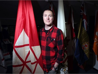 Shayne Campbell, who is the president and executive director of Settlers, Rails & Trails, show his pride for the famous Canadian Flag Collection housed at the local museum in Argyle, Man., located 50 kilometres northwest of Winnipeg, Man. on Friday, March 2, 2018. Campbell is standing next to a special occasion flag that was created for Canada's centennial in 1967. (Brook Jones/Stonewall Argus & Teulon Times/Postmedia Network)