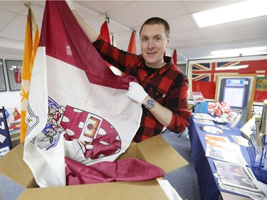 Shayne Campbell, who is the president and executive director of Settlers, Rails & Trails, holds out a McMaster University flag from the Ralph Spence collection which arrived at the local museum in Argyle, Man., located 50 kilometres northwest of Winnipeg, Man. on Friday, March 2, 2018. (Brook Jones/Stonewall Argus & Teulon Times/Postmedia Network)